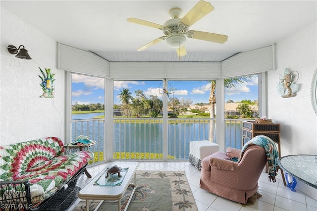 sunroom / solarium with a water view and ceiling fan