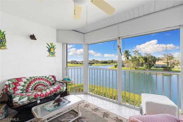 sunroom with a water view and ceiling fan