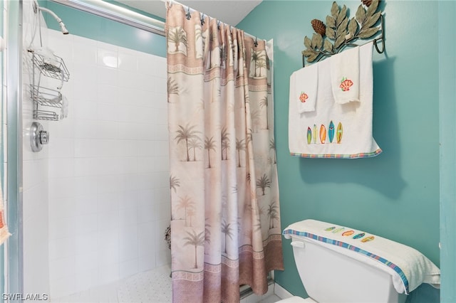 bathroom with a shower with curtain and toilet