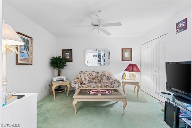 living room featuring light colored carpet and ceiling fan