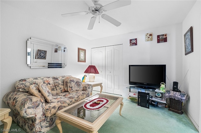 living room with ceiling fan and carpet