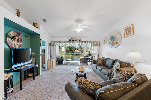 carpeted living room featuring vaulted ceiling and ceiling fan