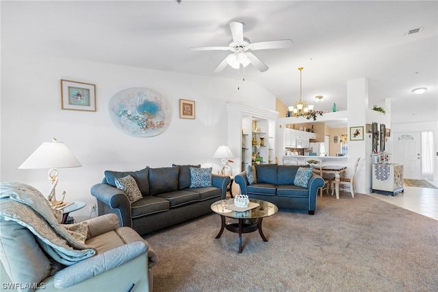 living room featuring light colored carpet, vaulted ceiling, and ceiling fan with notable chandelier