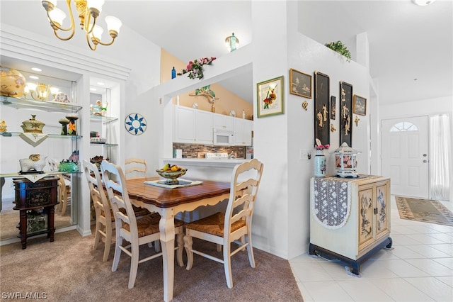 tiled dining room with high vaulted ceiling and an inviting chandelier