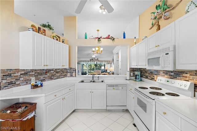 kitchen featuring backsplash, white appliances, sink, and ceiling fan with notable chandelier