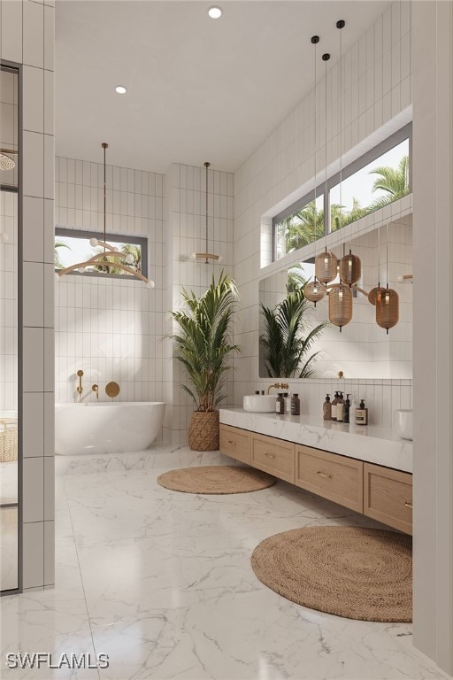 bathroom featuring a tub to relax in, tile walls, and vanity