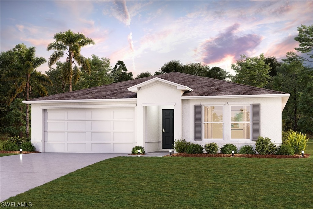 view of front of home with a lawn and a garage