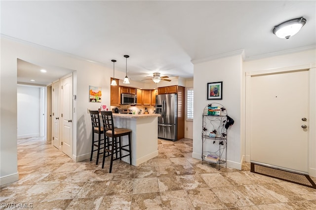 kitchen featuring stainless steel appliances, light tile floors, a kitchen bar, ceiling fan, and hanging light fixtures