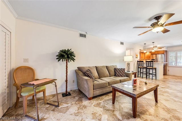 living room featuring ornamental molding, light tile flooring, and ceiling fan