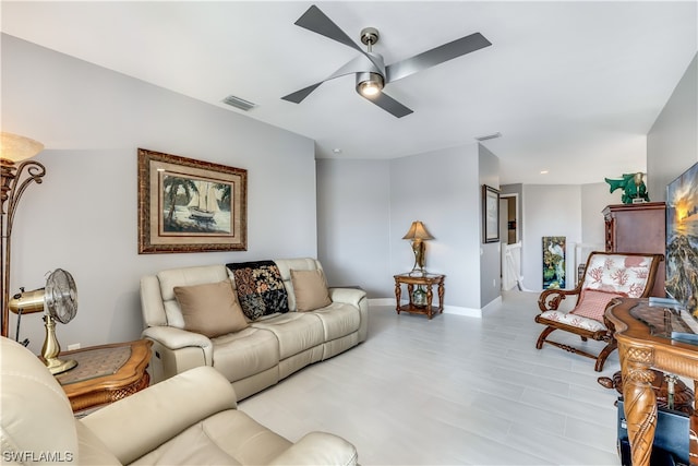 tiled living room featuring ceiling fan