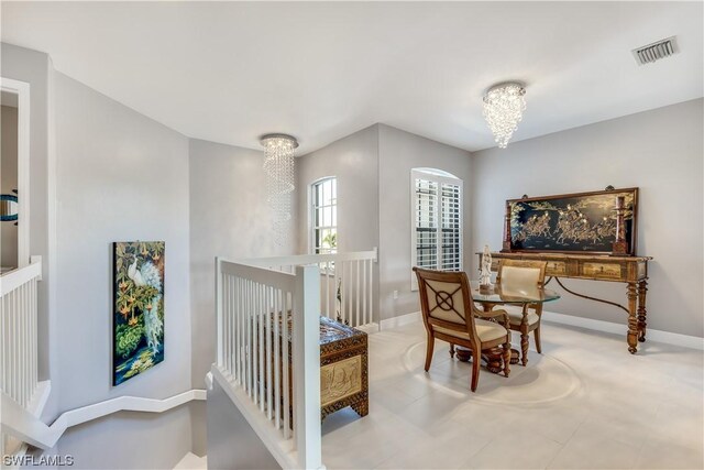 sitting room with light tile floors and a chandelier