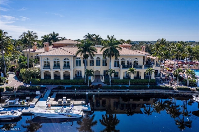 rear view of house featuring a water view