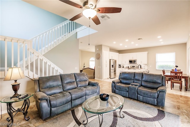 living room featuring light tile floors and ceiling fan