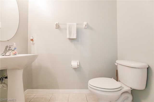 bathroom with toilet and tile floors