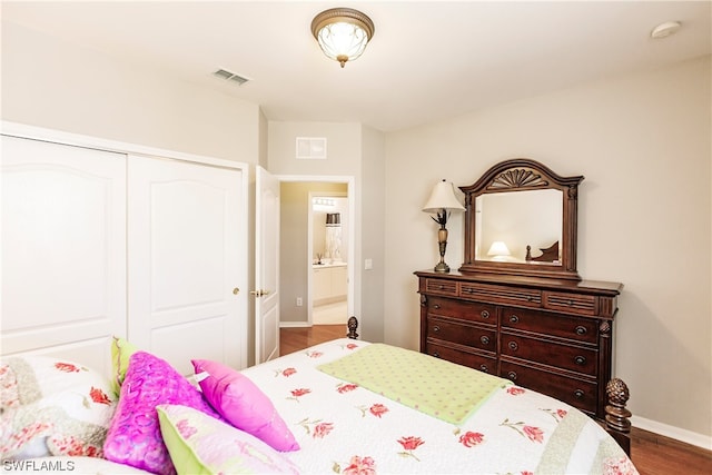 bedroom with a closet and dark wood-type flooring