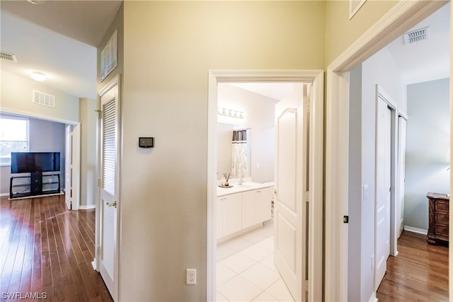 hallway featuring light tile floors