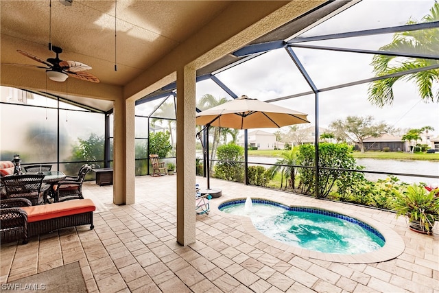 view of swimming pool with a patio area, glass enclosure, ceiling fan, and a hot tub