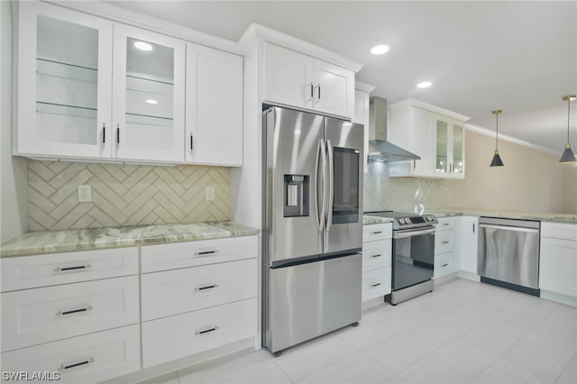 kitchen with decorative light fixtures, stainless steel appliances, light tile floors, wall chimney range hood, and tasteful backsplash