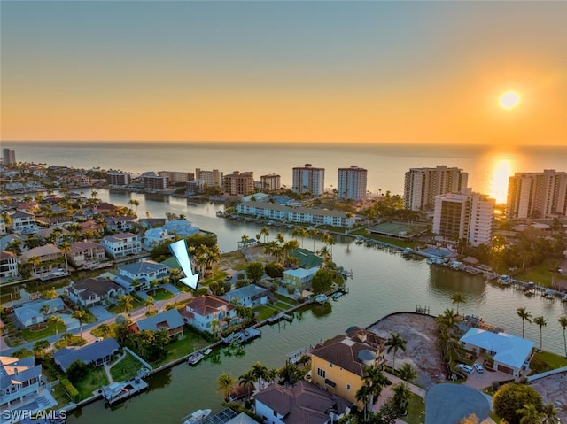 aerial view at dusk with a water view