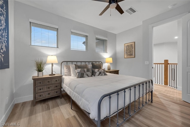 bedroom with ceiling fan and light wood-type flooring