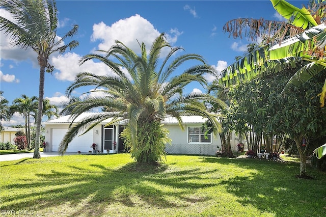 view of front of house with a front yard and a garage