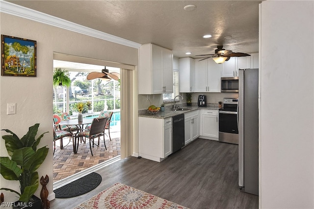 kitchen with white cabinets, stainless steel appliances, ceiling fan, and sink