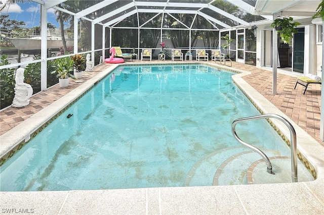 view of pool featuring a lanai and a patio