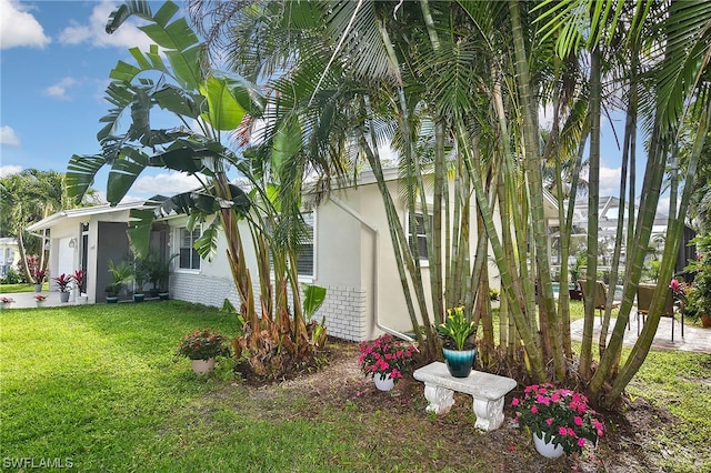 view of side of home featuring a lawn