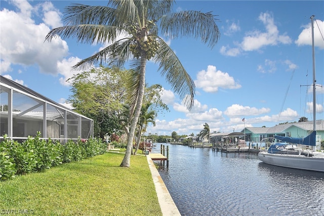 view of dock featuring a lanai, a lawn, and a water view