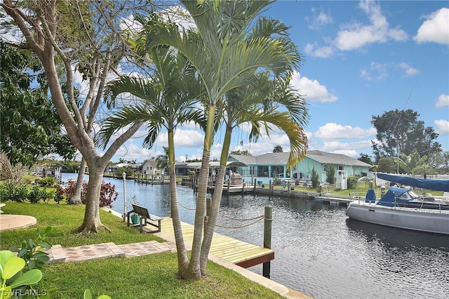 dock area with a water view and a lawn