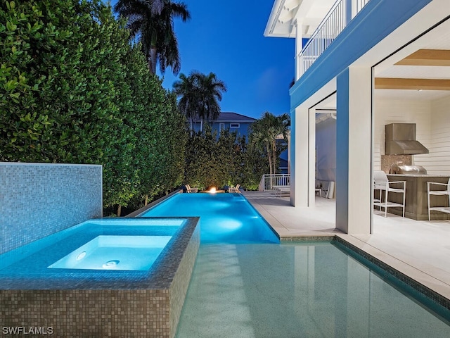 view of pool featuring a patio area and an in ground hot tub