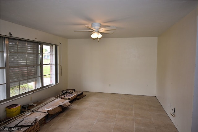 empty room with light tile patterned floors and ceiling fan