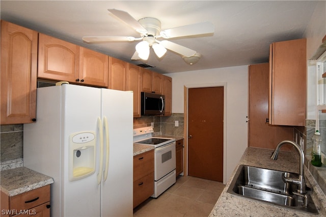 kitchen featuring white appliances, light tile patterned flooring, sink, ceiling fan, and decorative backsplash