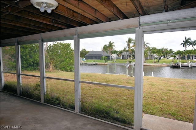 unfurnished sunroom featuring a water view and a wealth of natural light