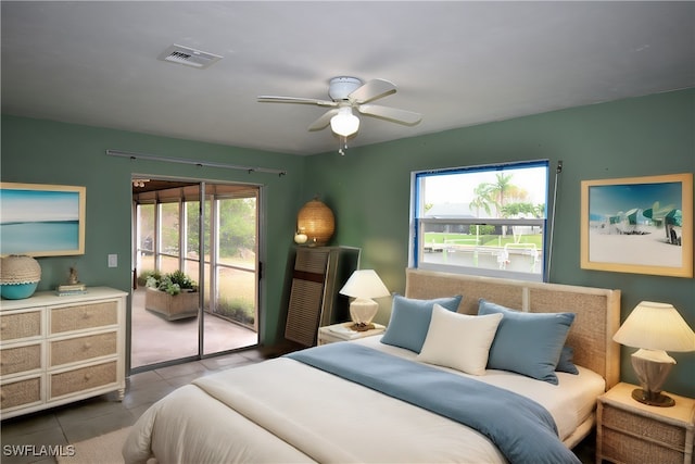 tiled bedroom featuring access to exterior, multiple windows, and ceiling fan