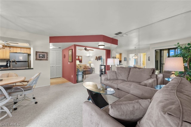 living room with light colored carpet and ceiling fan