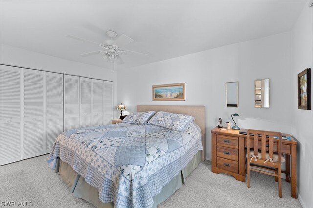 carpeted bedroom with a closet and ceiling fan