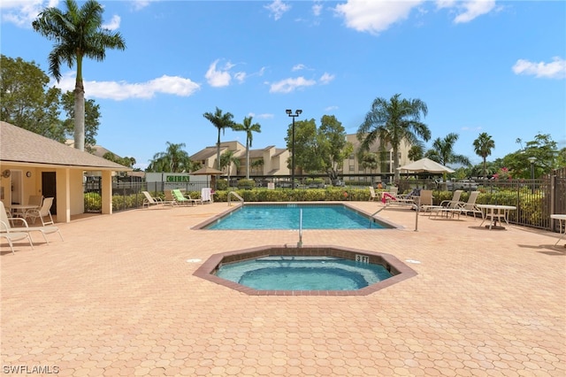 view of pool featuring a patio area and a hot tub