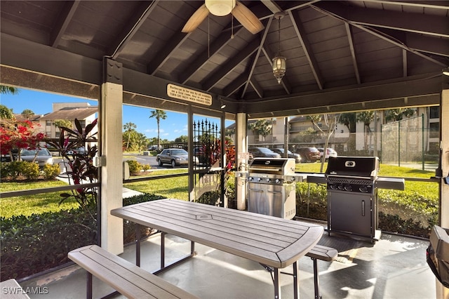 sunroom featuring ceiling fan, vaulted ceiling with beams, and wood ceiling