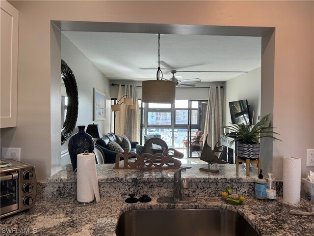 living room featuring ceiling fan and sink