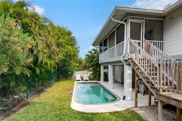 view of pool featuring a patio area and a sunroom