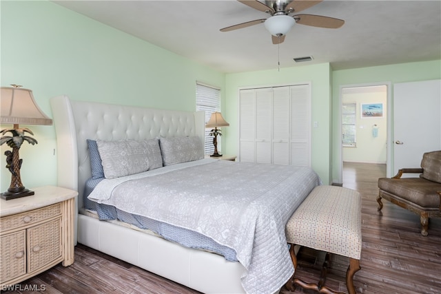 bedroom with a closet, ceiling fan, and dark hardwood / wood-style floors