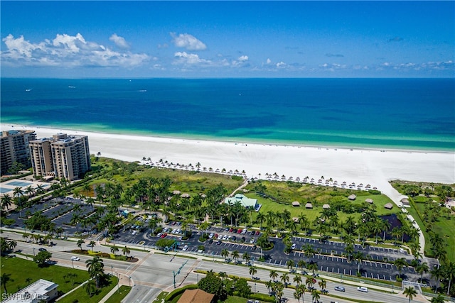 drone / aerial view with a water view and a beach view