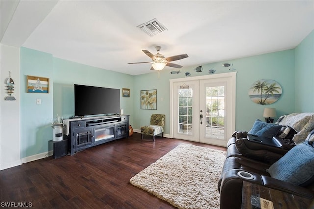 living room with dark hardwood / wood-style floors, ceiling fan, and french doors