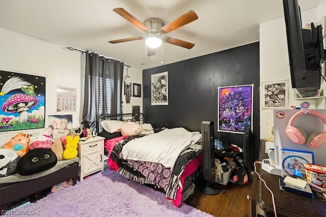 bedroom featuring ceiling fan and dark hardwood / wood-style flooring