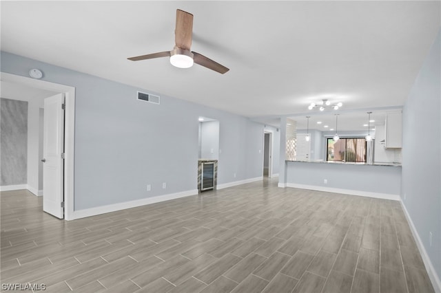 unfurnished living room with light hardwood / wood-style floors and ceiling fan