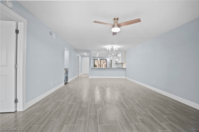 unfurnished living room featuring ceiling fan and light wood-type flooring