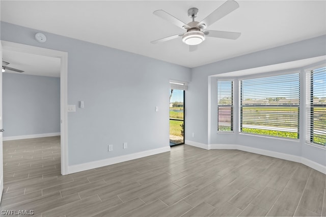 unfurnished room with ceiling fan and light wood-type flooring