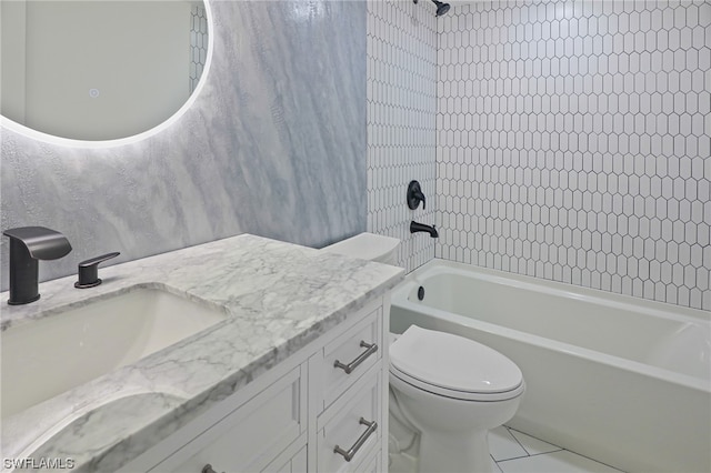 full bathroom featuring tile floors, toilet, vanity, and tiled shower / bath