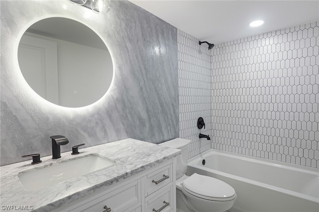 full bathroom featuring tiled shower / bath combo, toilet, and vanity